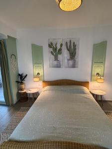 a bedroom with a large bed with two tables at T H E BERLIN Studios and Suites in Nea Vrasna