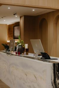 a reception counter with two laptops on top of it at Pana Unique Semey in Semey