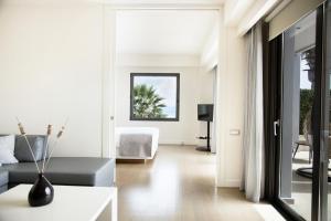 a living room with a couch and a table at Cavo Olympo Luxury Hotel & Spa - Adult Only in Plaka Litochorou