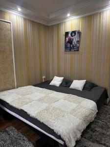 a bedroom with a large bed in a room at Jarosta Premium Hotel in Chişinău