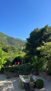 two chairs and a bench in a garden at La Césarine in Nyons +9 photos
