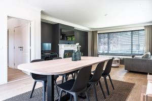 a dining room and living room with a table and chairs at roeselare stay in Roeselare