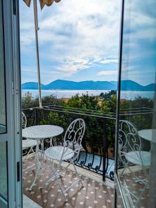 a balcony with tables and chairs and a view of the ocean at La vela latina in Lerici
