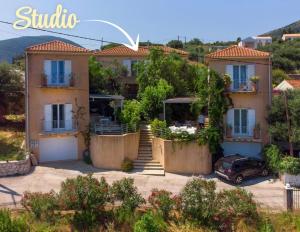 a house with a car parked in front of it at FOS Ionian Breeze Studio in Platithriás