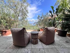 two chairs and a tree stump sitting on a patio at FOS Ionian Breeze Studio in Platithriás +19 photos