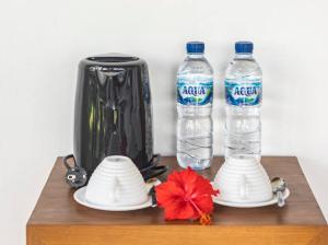 a table with two bottles of water and a blender at Ritual Ubud in Gianyar