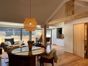 a dining room and living room with a table at Ari Apartment Wald am Arlberg in Wald am Arlberg