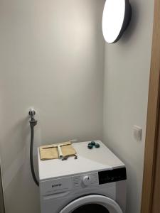 a washing machine with a light on top of it at Ari Apartment Wald am Arlberg in Wald am Arlberg