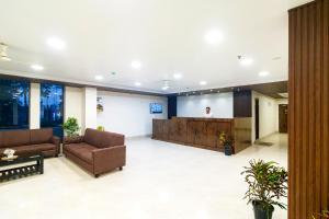 a lobby with a man on a screen in a building at Hotel Sagar Sonnet in Haldia
