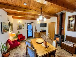 a living room with a table and a fireplace at Papa Franks House in Ptuj