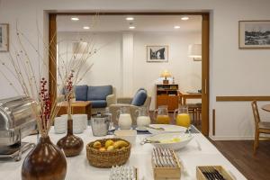 ein Wohnzimmer mit einem Tisch, auf dem Essen steht in der Unterkunft Hotel Pinhal Mar in Peniche + 21 Fotos