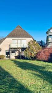 a house with a large lawn in front of it at Veermaster 1 in Breege