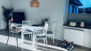 a dining room with a white table and chairs at Veermaster 1 in Breege