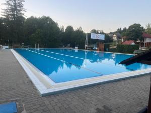 a large swimming pool with blue water at Panoráma Vendégház in Igal +18 photos