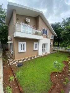 a large house with a lawn in front of it at Nirvana Villa Karjat in Dhamni