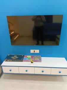a tv sitting on top of a white dresser at Nirvana Villa Karjat in Dhamni
