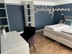 a bedroom with a bed and a desk with a sign on the wall at Ferienwohnung 1-4 Personen in Goslar in Goslar +26 photos