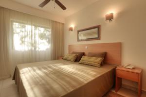 a bedroom with a large bed and a window at 3HB Falésia Garden in Albufeira +21 photos