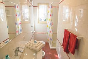 a bathroom with a sink and a toilet and a shower at Villa Ginanneschi - Le Pitte in Capoliveri