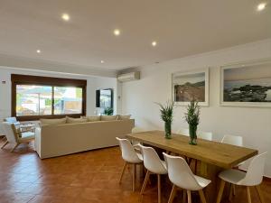 a living room with a table and a couch at Villa Sa Punta in Cala en Blanes