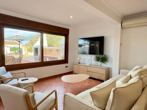 a living room with a couch and a table at Villa Sa Punta in Cala en Blanes