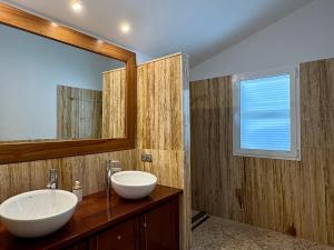 a bathroom with a sink and a mirror at Villa Sa Punta in Cala en Blanes +14 photos