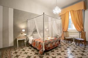 a bedroom with a canopy bed in a room at Residenza Centro Storico in Lucca