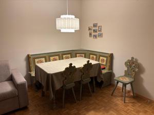 a dining room with a table and two chairs at Passo Carezza Club Apartment in Carezza al Lago