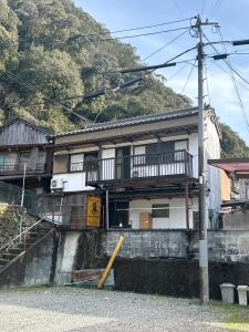 a building with a balcony on the side of it at tsudoi in Tanabe