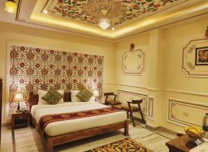 a bedroom with a bed in a room with a ceiling at Hotel The Rajputana Ranthambore in Sawāi Mādhopur