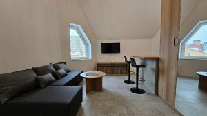 a living room with a couch and a table at Fieldorfa House in Ostrołęka