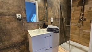 a bathroom with a sink and a shower at Fieldorfa House in Ostrołęka