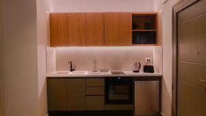 a kitchen with a sink and a stove at Cosmos Residences in Vasiliki