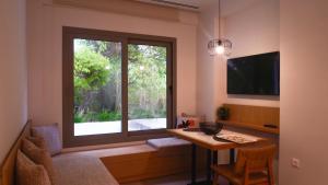 a room with a table and a large window at Cosmos Residences in Vasiliki