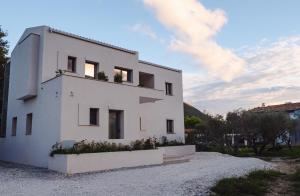 a white house with plants on top of it at Cosmos Residences in Vasiliki