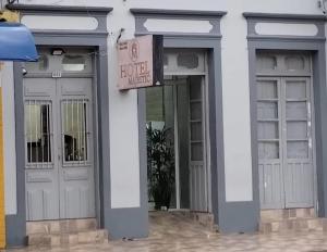 a building with two doors and a hotel sign on it at Hotel Majestic in Pelotas