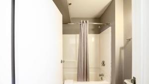 a shower with a shower curtain in a bathroom at Motel 6-Wethersfield, CT - Hartford in Wethersfield