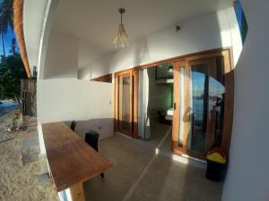 a room with a wooden table in a house at Alfa Beachfront Lofts in El Nido