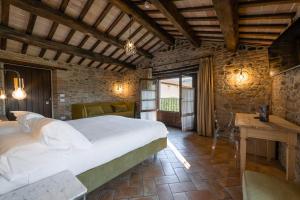 a bedroom with a large white bed in a room at Ca' Virginia Country House Wellness in Montecalvo in Foglia +75 photos