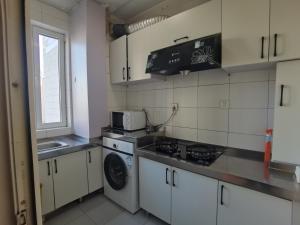 a kitchen with a stove and a sink and a microwave at Times International in Beijing