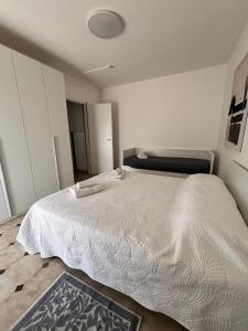 a bedroom with a large white bed in a room at Lucys Home Giardini Naxos in Giardini Naxos