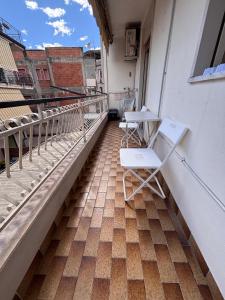 two chairs and a table on a balcony at Lucys Home Giardini Naxos in Giardini Naxos +5 photos