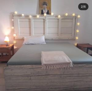 a bedroom with a large bed with lights on it at B&B Antica Neviera in Gioia del Colle