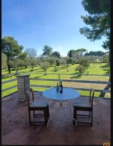a table and chairs with a view of a field at B&B Antica Neviera in Gioia del Colle