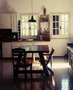 a kitchen with a wooden table and two chairs at B&B Antica Neviera in Gioia del Colle +15 photos