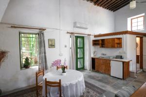 a kitchen and a table in a room with a table and a kitchen at Antonys Garden House in Episkopi Limassol +15 photos