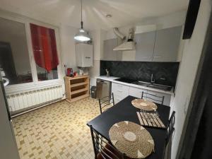 a small kitchen with a table and chairs in it at L'appart du Château in Blois