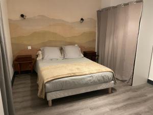 a bedroom with a bed with a painting on the wall at L'appart du Château in Blois
