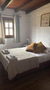 a bedroom with a large bed with two towels on it at Chacra Dosvistas in Maldonado +38 photos
