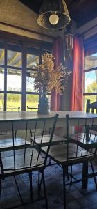 a dining room table with a vase on top of it at Chacra Dosvistas in Maldonado